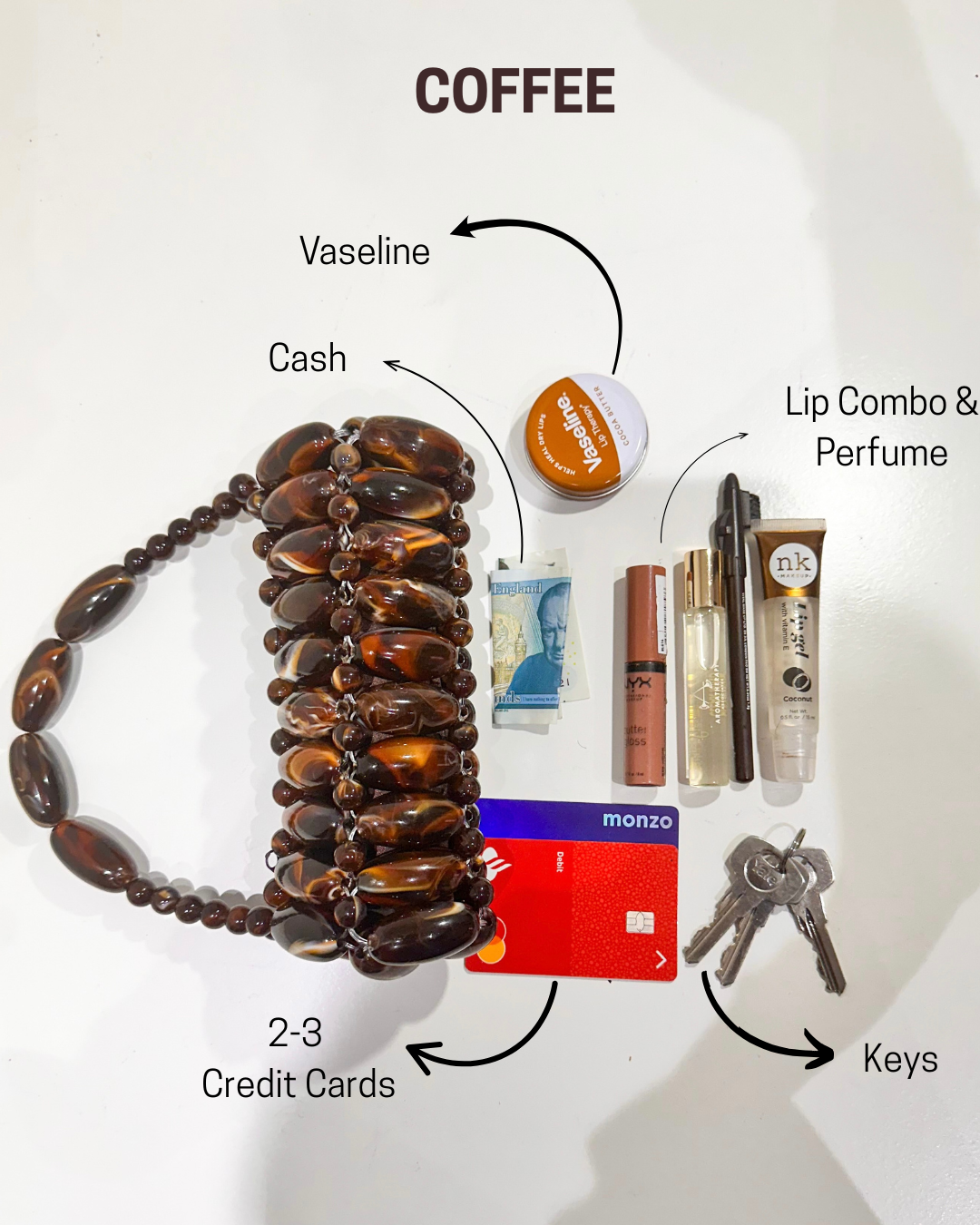 Collection of everyday items including a beaded bracelet, coffee, cash, lip combo, perfume, keys, and credit cards on a white surface, showing what can fit in the coffee handmade beaded bag