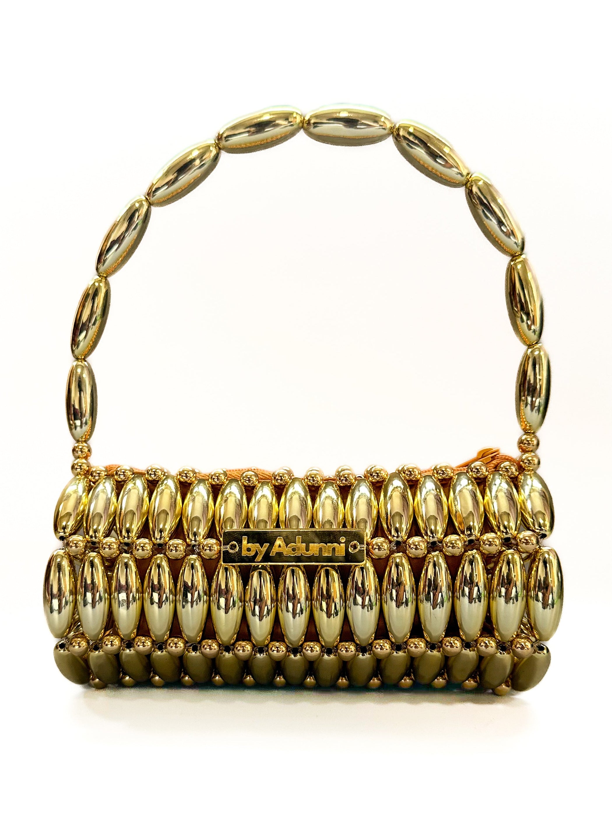 Gold handbag with pearl-like embellishments on a white background
