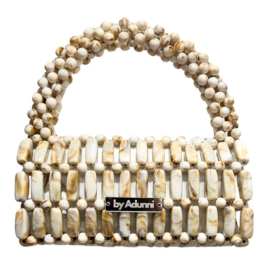 Beaded handbag with 'by Adunni' label on a white background