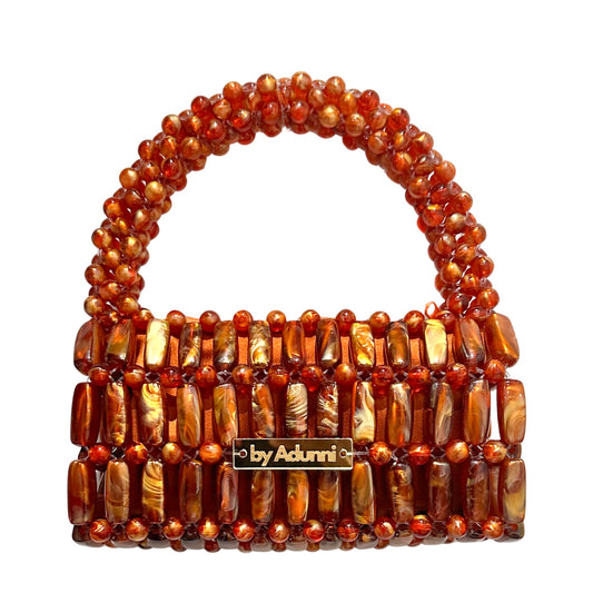 Beaded handbag with 'by Adunni' label on a white background