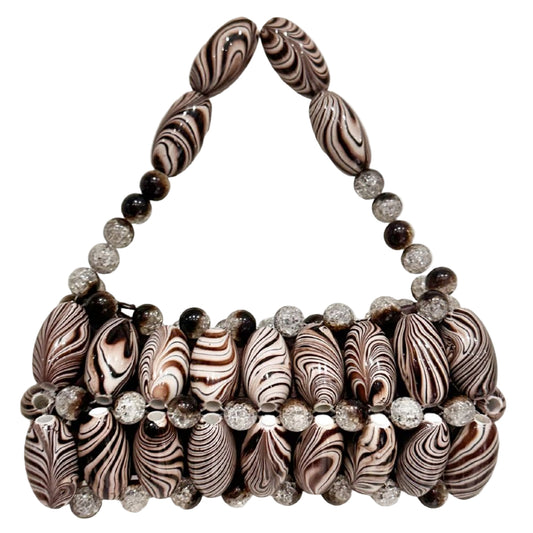 A handcrafted handbag featuring handpicked beads with a brown zebra pattern and embellishments.