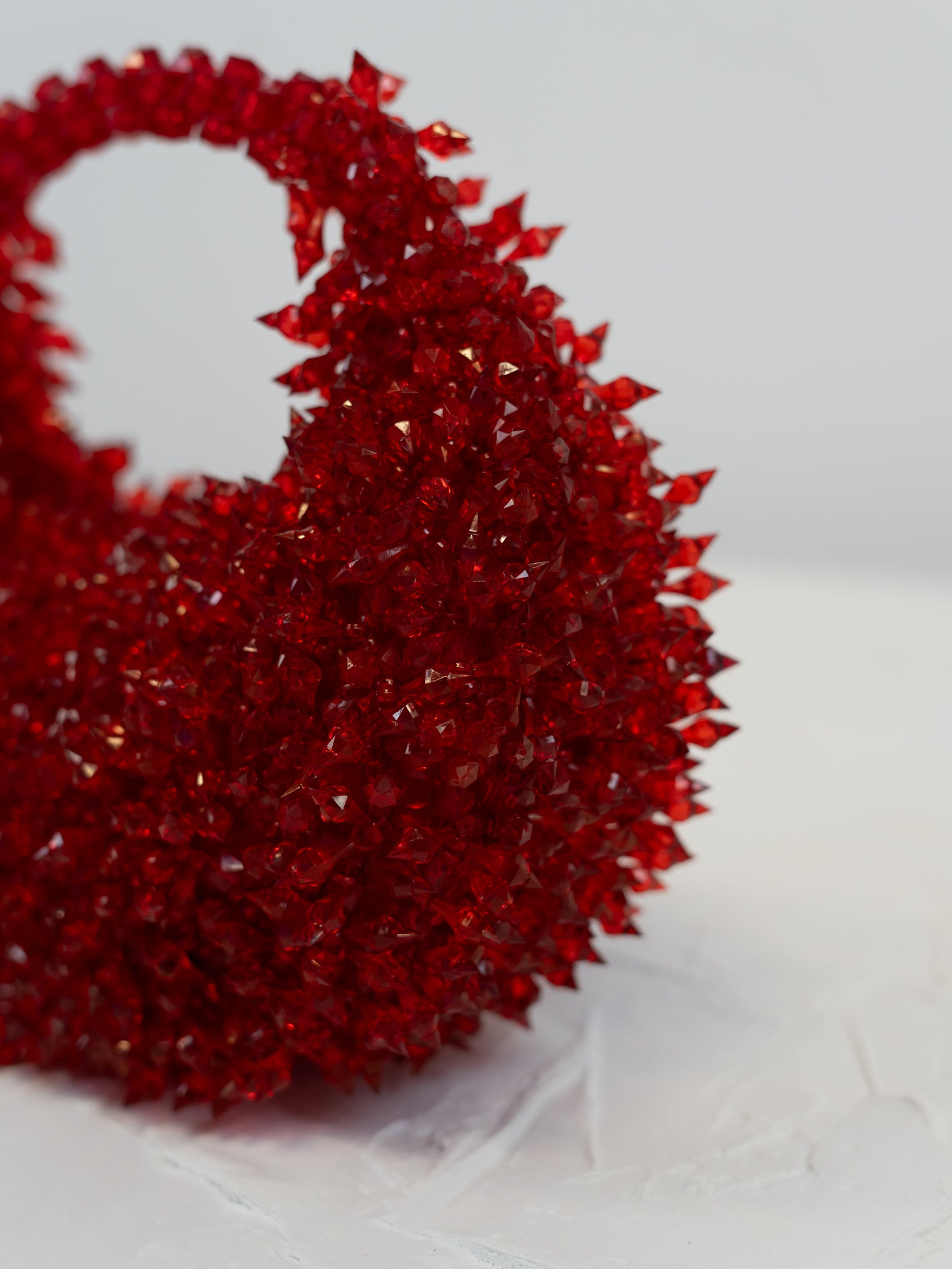 Red textured handbag on a white background