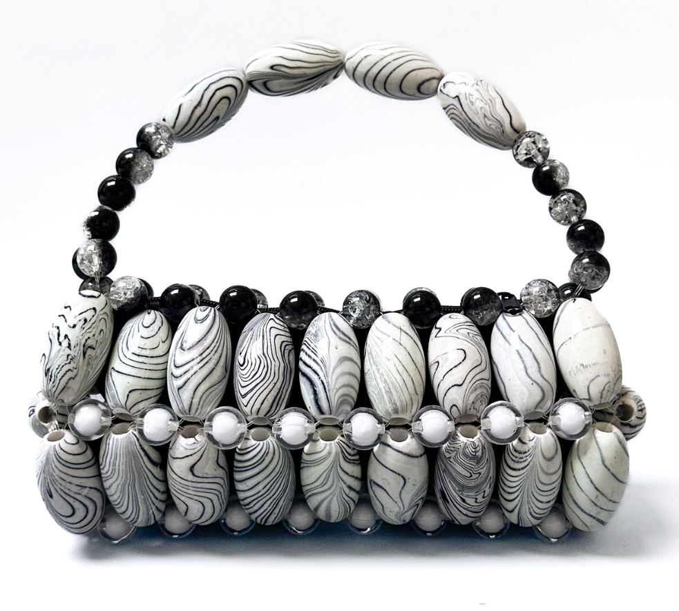Close up of white zebra beaded bag with marble striped black tones and white beads