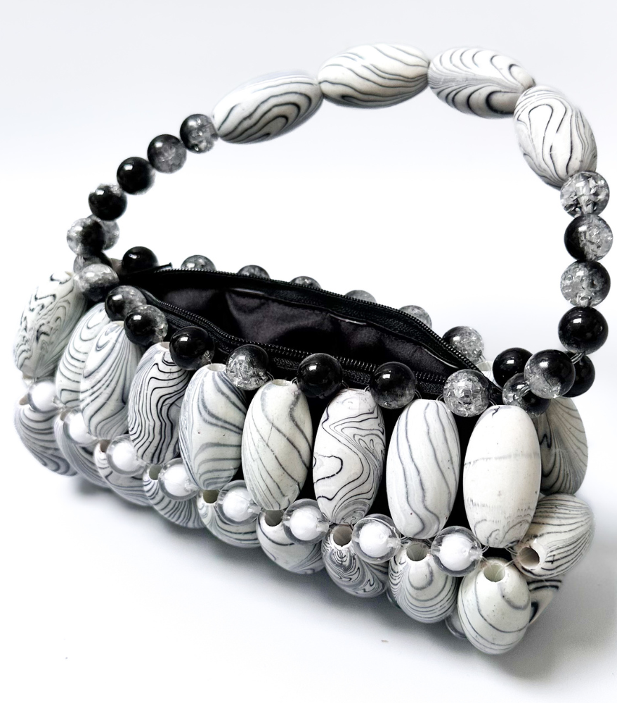 Top view of white zebra beaded bag, part of the monochrome marble collection, featuring a black open zip pouch
