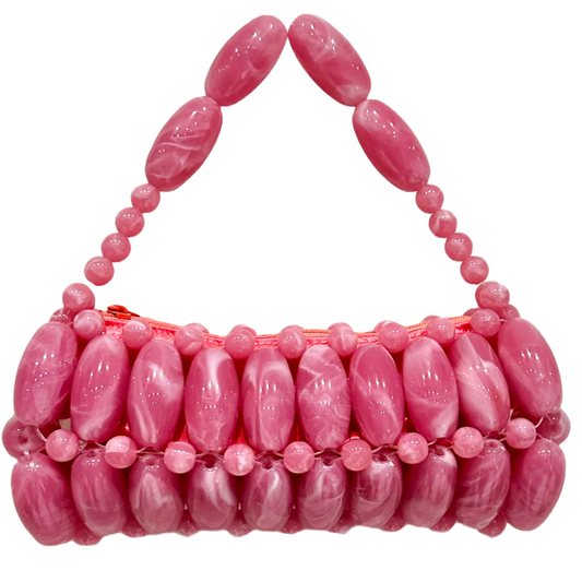 Pink beaded handbag on a white background