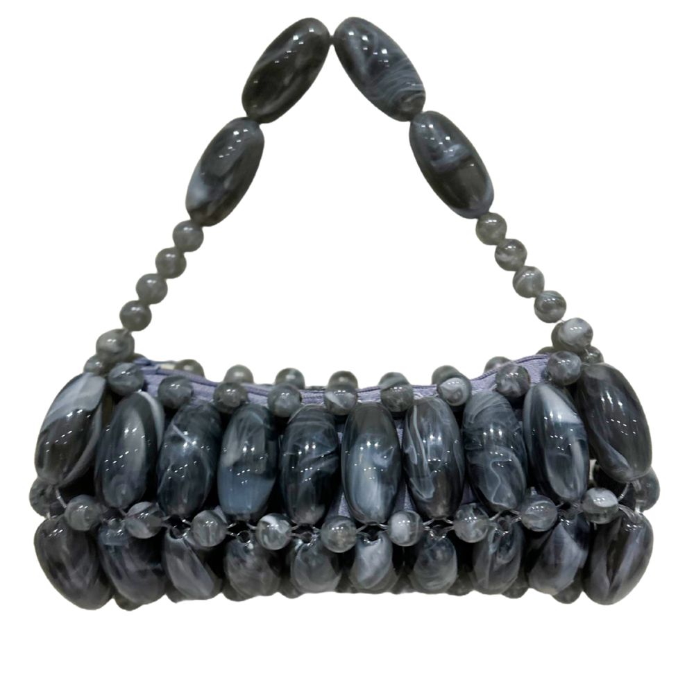 A handcrafted handbag made with handpicked beads in gray color.