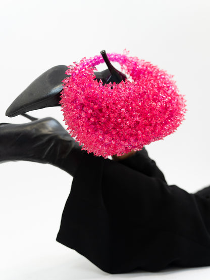 Model holding hot pinked spiked handbag on heeled boot