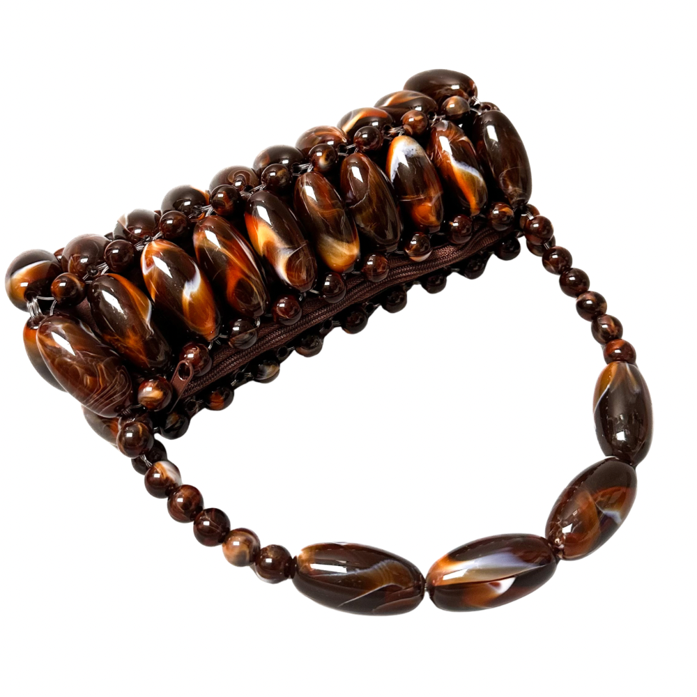 Close up of handmade beaded bag in coffee, part of the tortoise shell marble collection laid flat showing the brown zip pouch - orange and dark brown, coffee tones