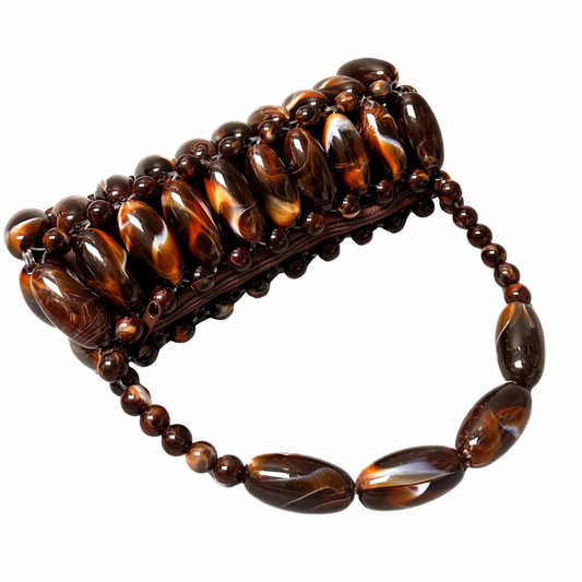 Close up of handmade beaded bag in coffee, part of the tortoise shell marble collection laid flat showing the brown zip pouch - orange and dark brown, coffee tones