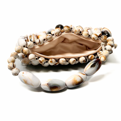 View of inside the cream marble beaded bag, part of the tortoise shell marble collection