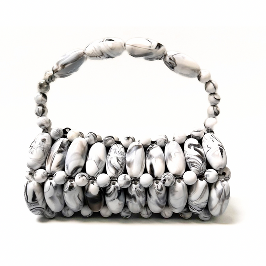 Close up of handmade beaded bag in frosted stone - black, white marble swirled tones