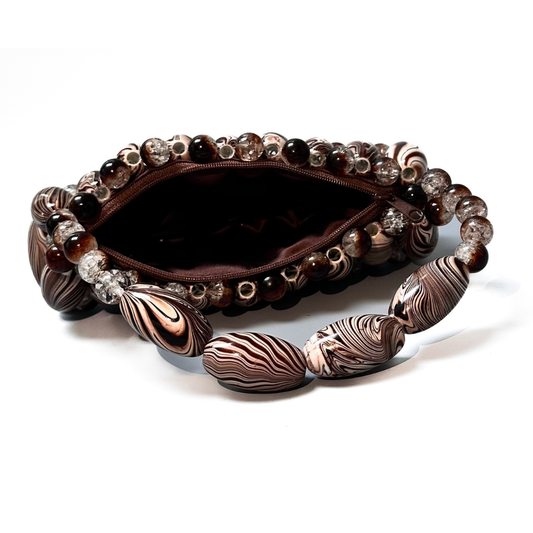 Close up of handmade beaded bag in brown zebra, part of the monochrome marble collection open laid flat displaying the brown zip pouch - brown, light brown, dark brown striped tones