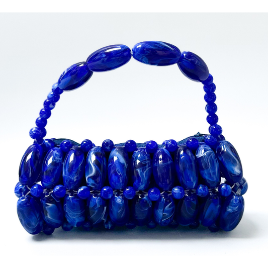Close up of handmade beaded bag in electric blue, dark blue, light white marble swirled tones