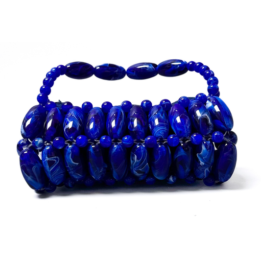 Close up of handmade beaded bag in electric blue, dark blue, light white marble swirled tones