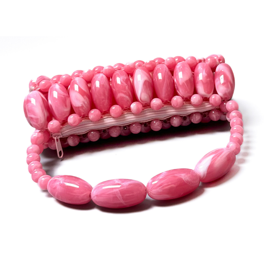 Fuchsia Pink Beaded bag close up laid flat featuring light pink zip pouch