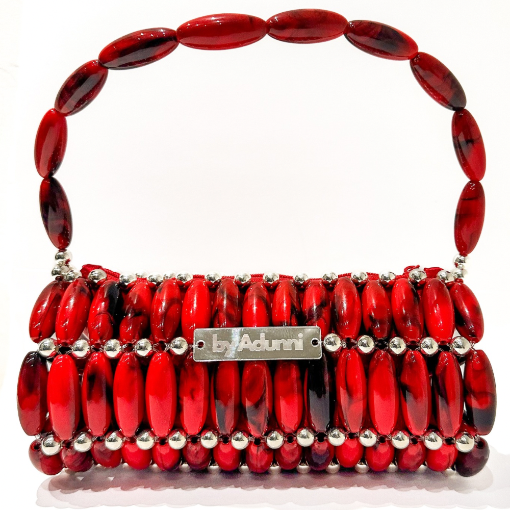 Red beaded barrel handbag with silver accents on a white background