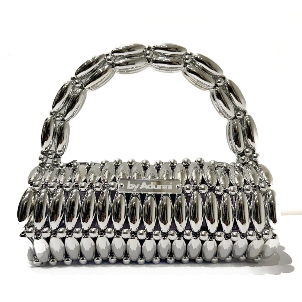 Close up of platinum barrel beaded bag with thick handle - silver tones