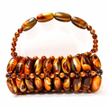 Close up of handmade beaded bag in madagascar - orange and brown tones