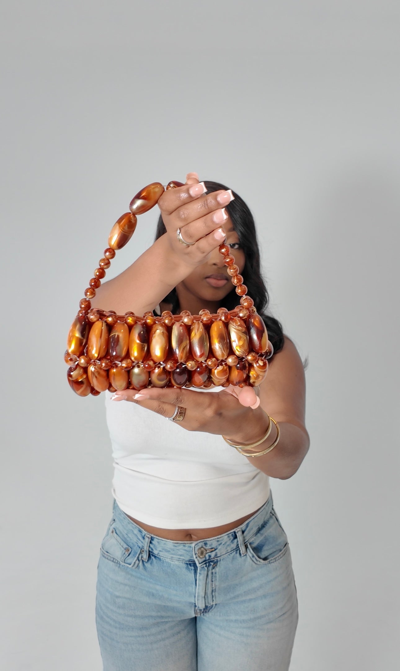 Model holding handmade madagascar beaded bag