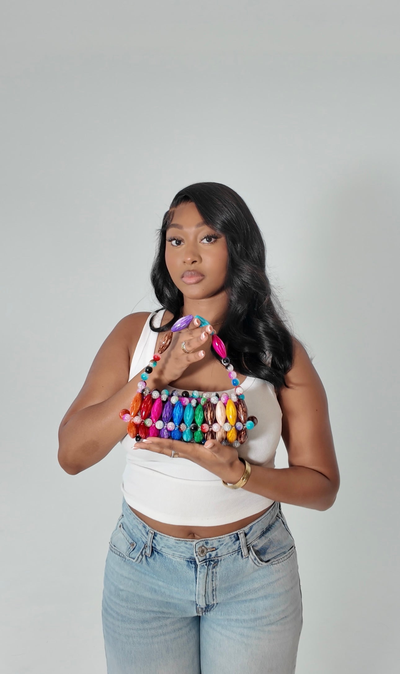 Model holding handmade beaded bag in candy - brown, blue, purple, pink, red, orange, green, beige, yellow beads