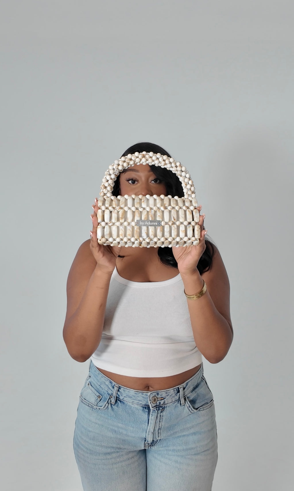 Model holding Cream Marble XL handmade beaded bag