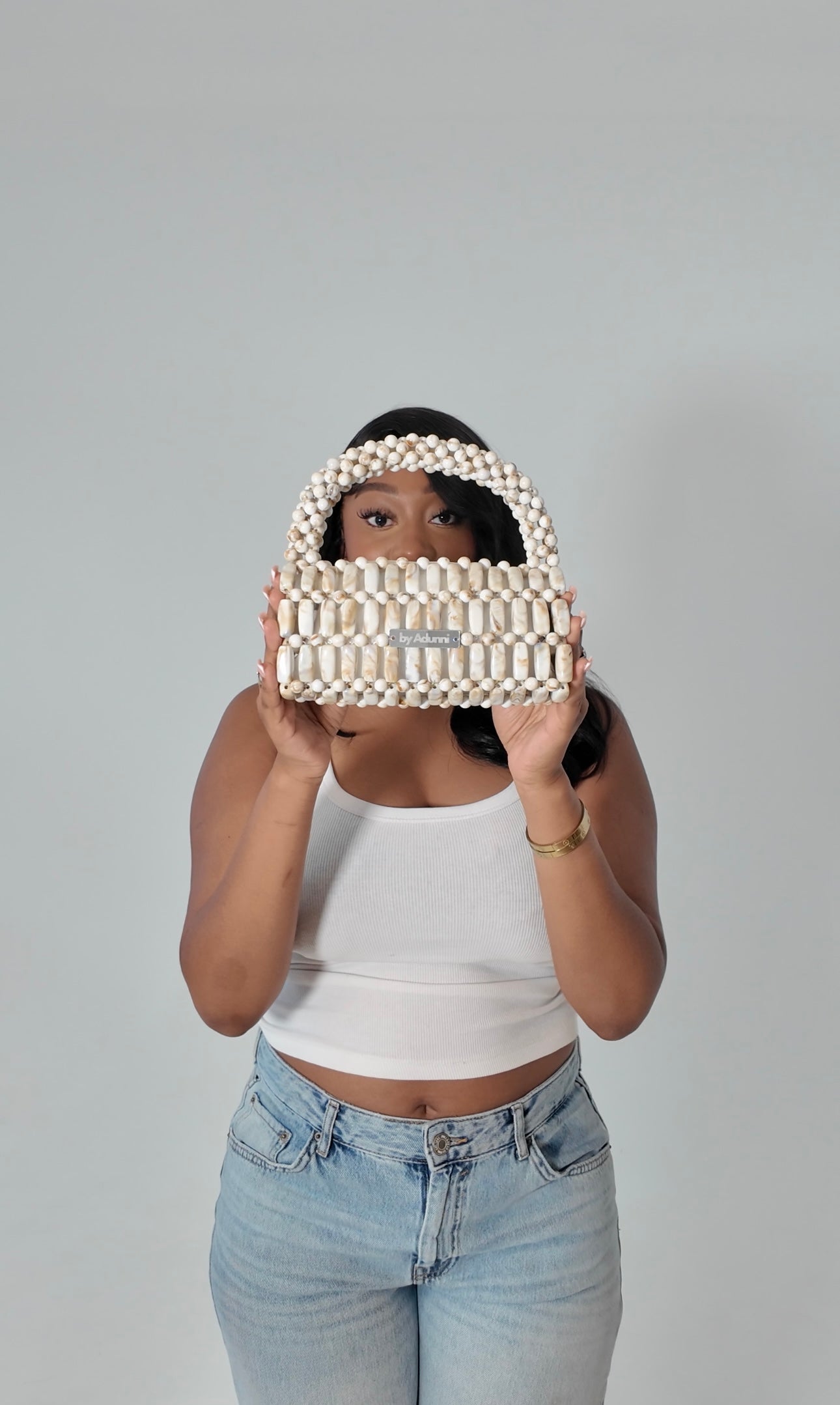 Model holding Cream Marble XL handmade beaded bag