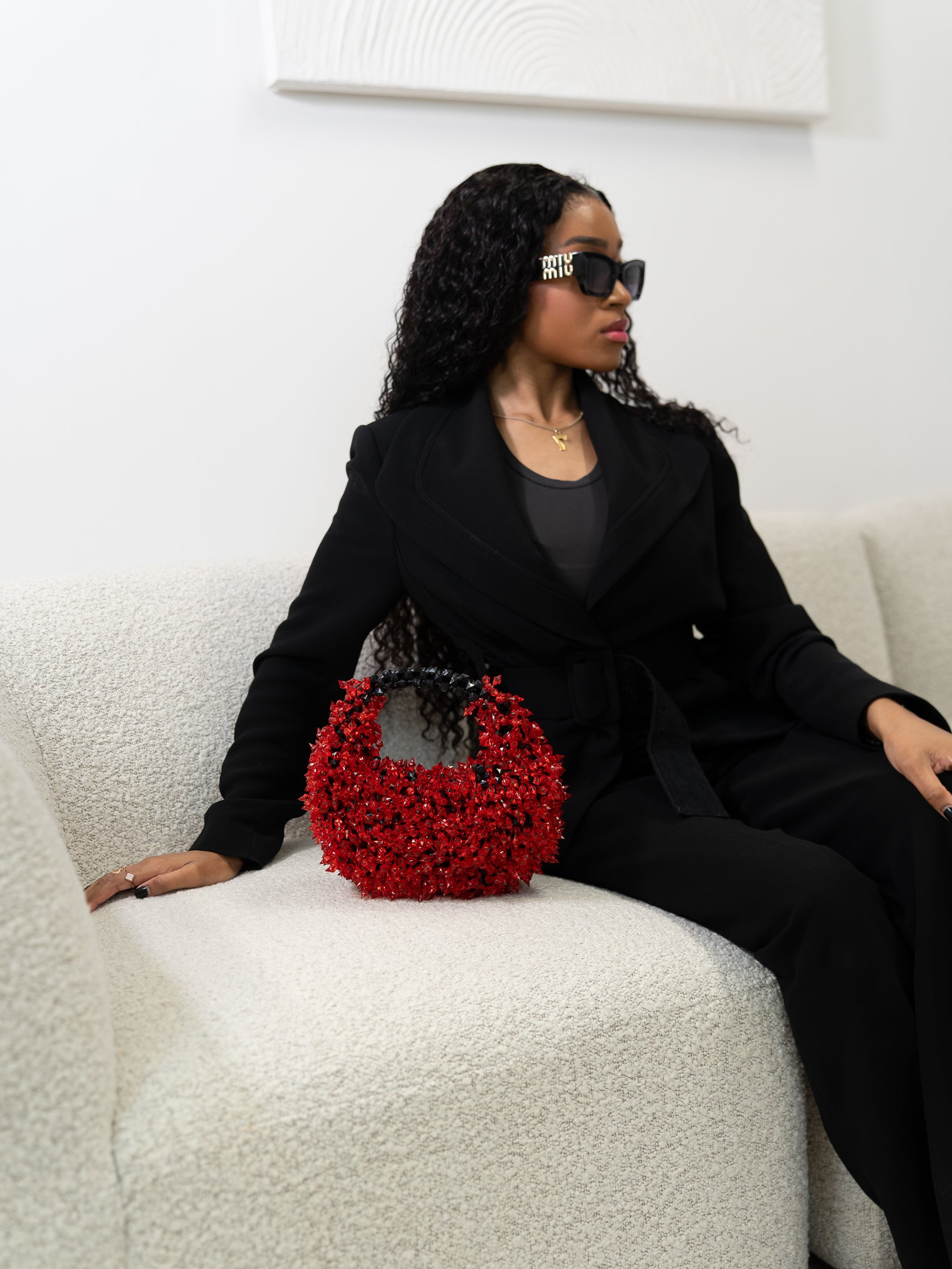 Woman holding a red handbag with a white background