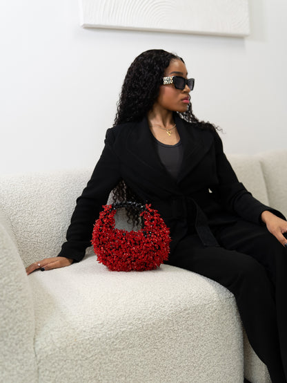 Woman holding a red handbag with a white background