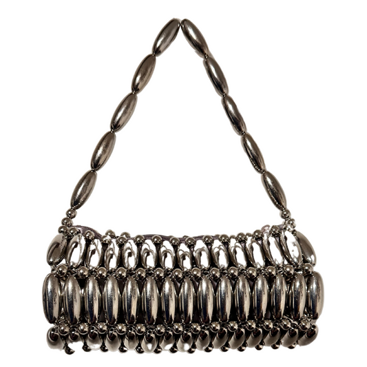Silver handbag with beaded handle and base on a white background
