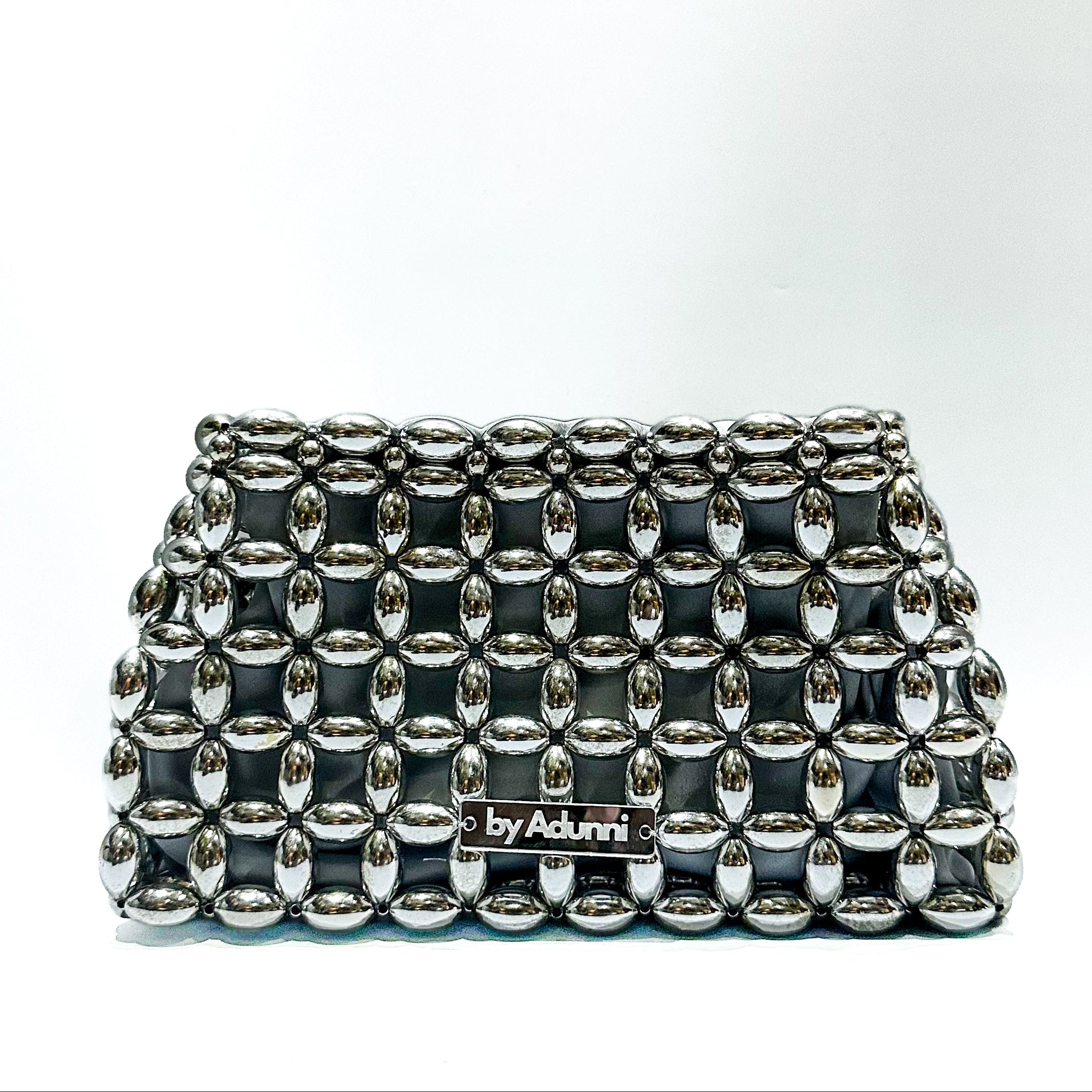 silver studded clutch bag on a white background