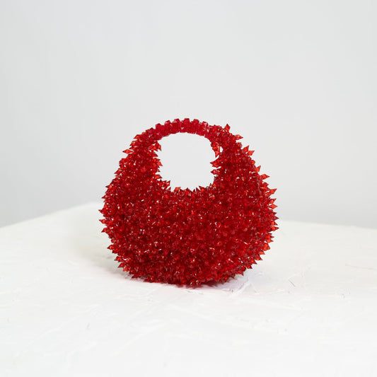 Red textured handbag on a white background