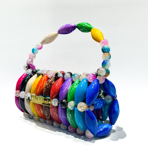 Colorful beaded handbag with a rainbow pattern on a white background