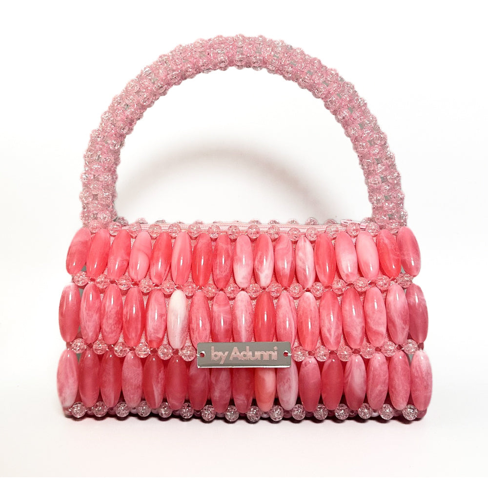 Pink beaded handbag with 'by Adunni' label on a white background