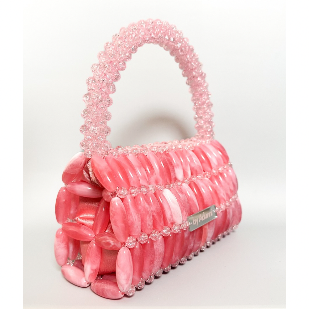 Pink beaded handbag with a visible brand name on a white background